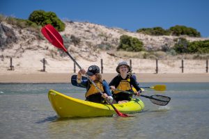 Two children in a yellow kayak